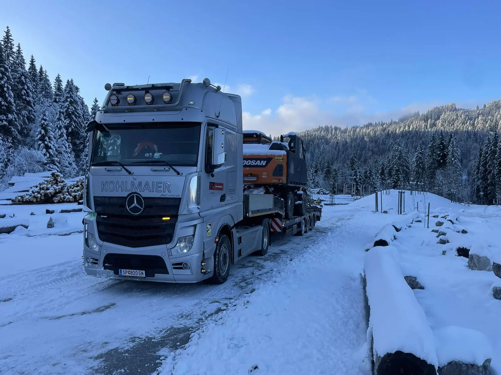Excavator transport over an Alpine pass in winter