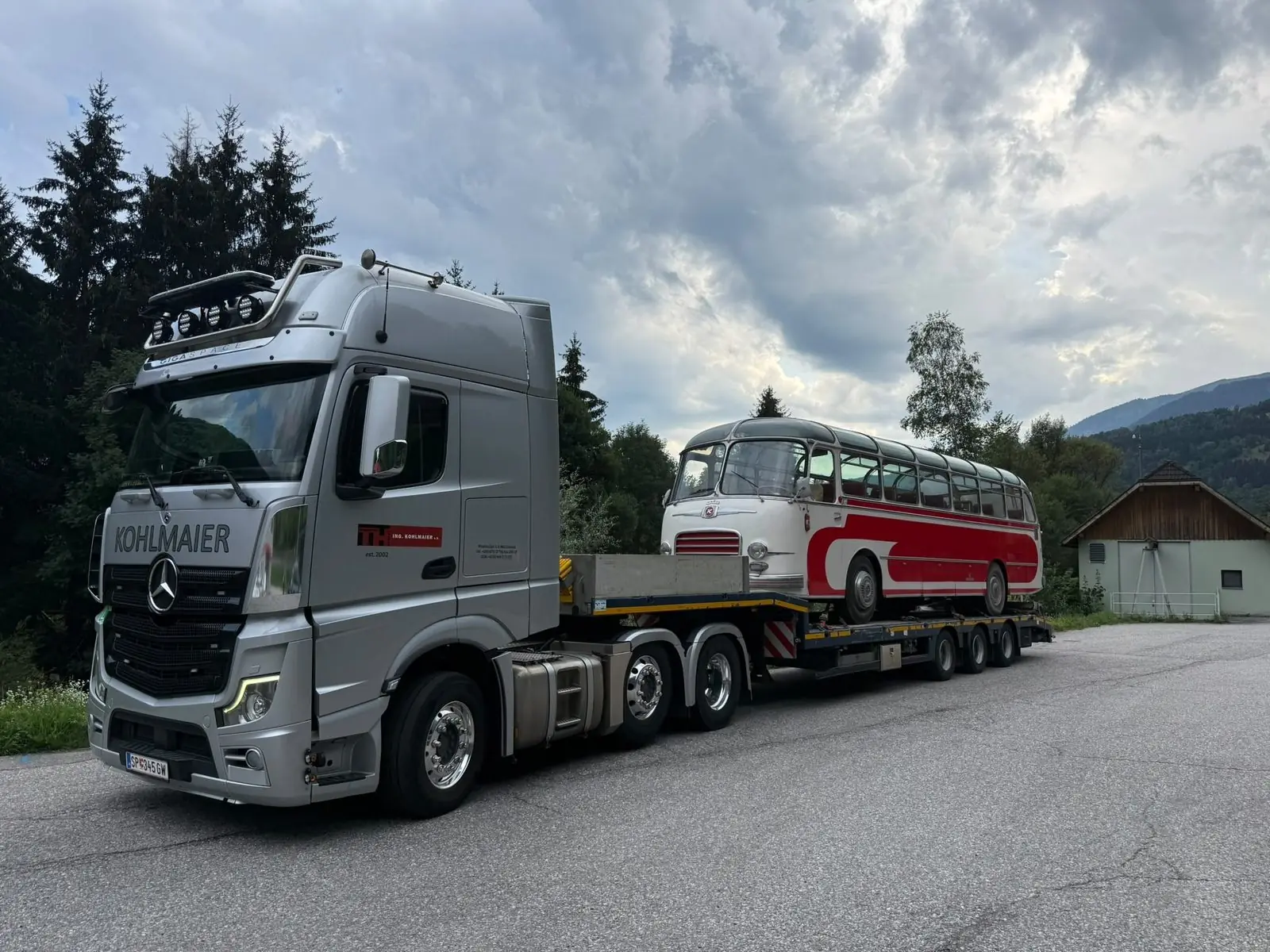 Vintage bus as a special transport on the low loader